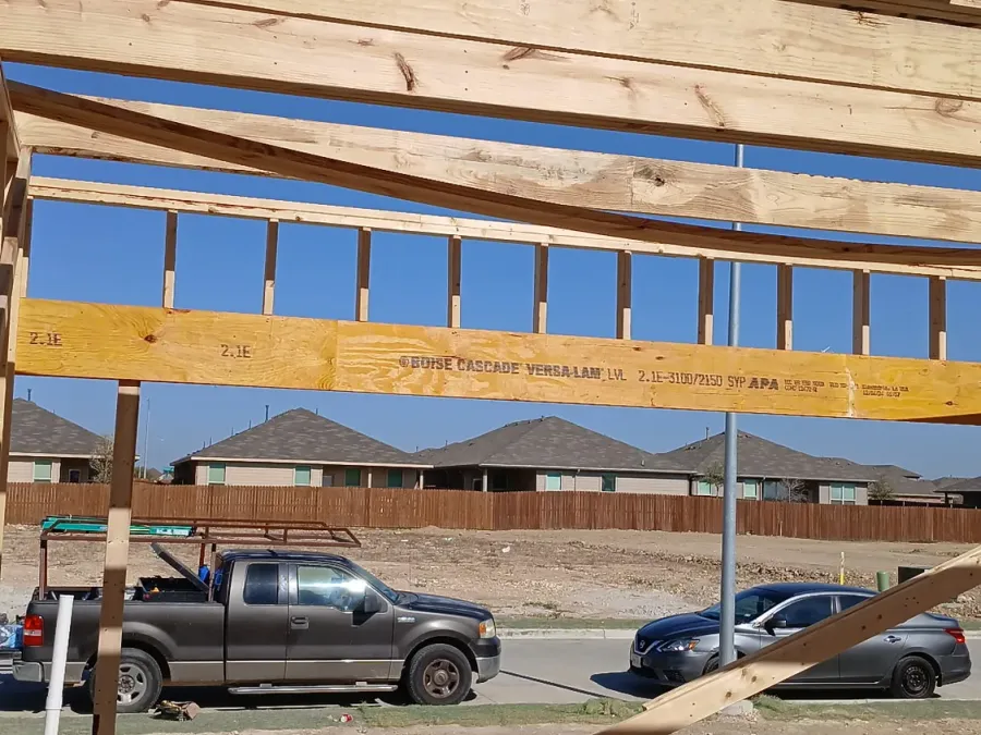 Engineered LVL header beam carrying a long opening in a wood frame wall